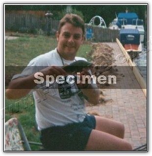 Robin in 2004, overweight, sitting by the water on a fishing trip, photo stamped Specimen